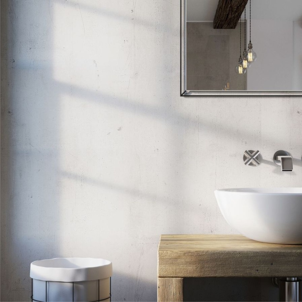 Lifestyle image of the Showerwall Laminate Urban Concrete 2440mm x 1179mm Proclick MDF Wall Panel - SW48 installed within a bathroom with white basin & rectangle mirror